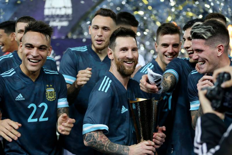 Lionel Messi celebrates with a trophy alongside Lautaro Martinez and teammates after Argentina's 1-0 win over Brazil. Reuters