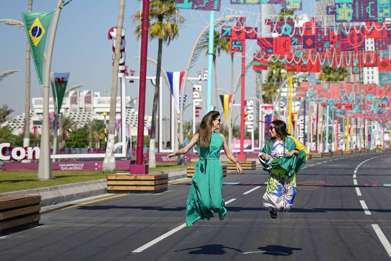 Brazil fans jump for joy on Doha Corniche in Qatar. AP