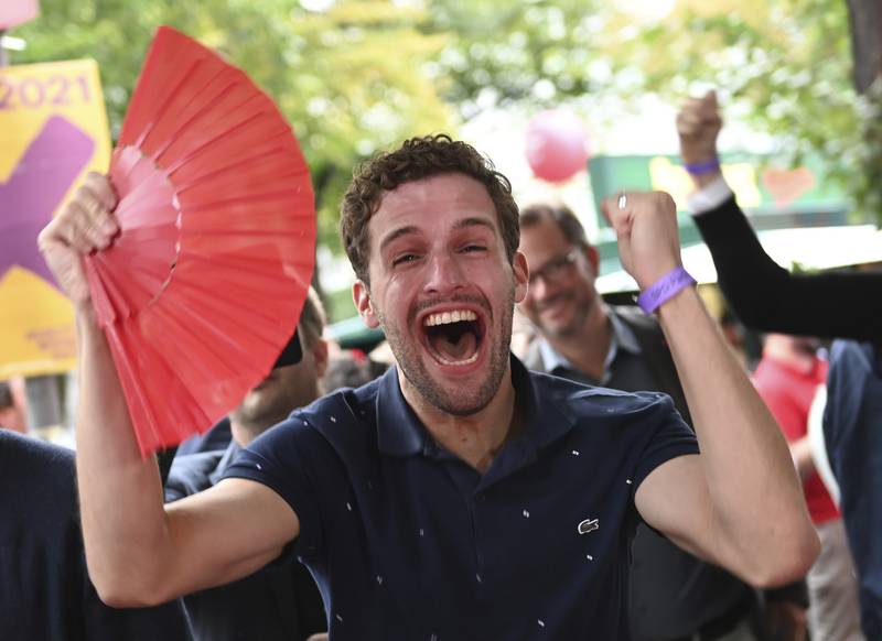 Supporters of the SPD react to the first results of the federal election in front of the Willy Brandt House, Berlin. AP