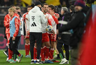 Harry Kane with Bayern manager Thomas Tuchel and the match ball after his hat-trick against Dortmund. AFP