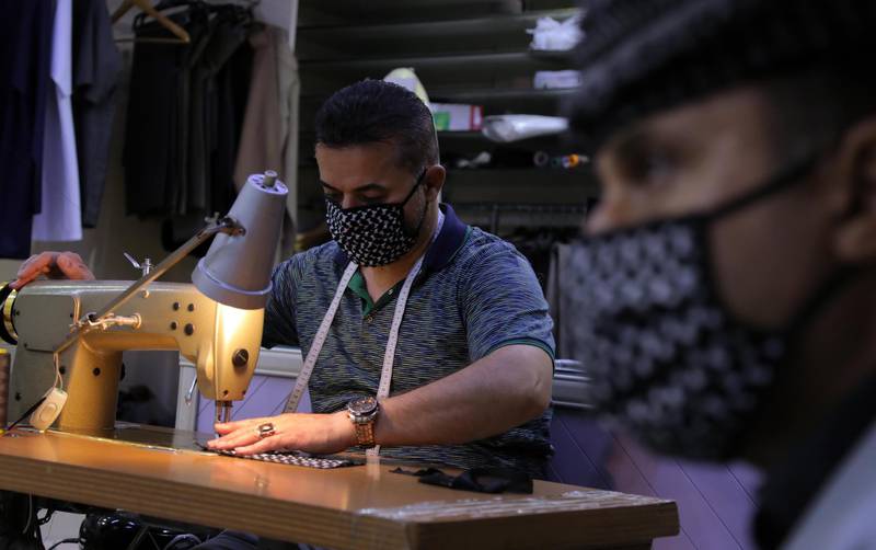 A Kurdish tailor makes face masks out of keffiyeh fabric  in Erbil, northern Iraq. AFP