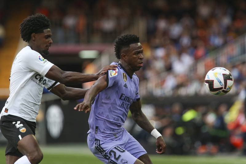 Real Madrid's Vinicius Junior, right, duels for the ball with Valencia's Thierry Correia. AP Photo