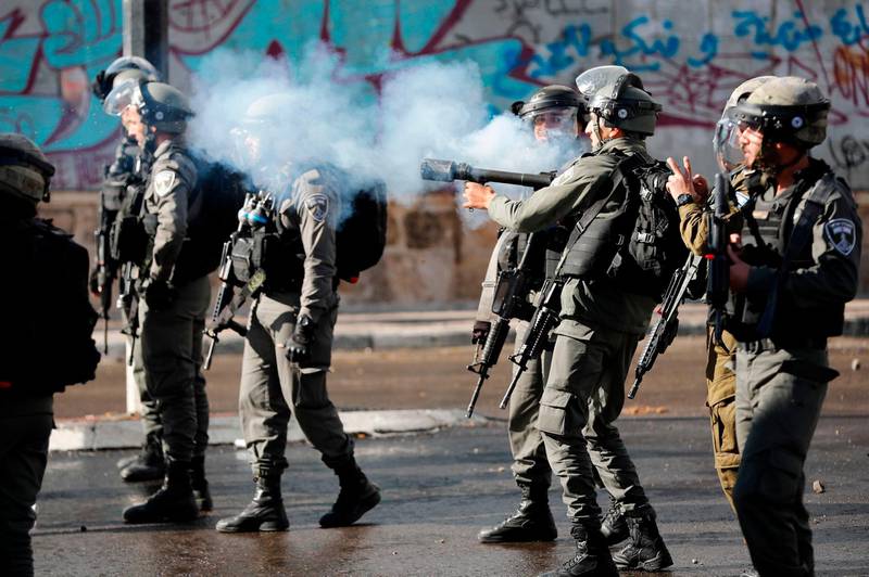 Israeli forces clash with Palestinian protesters near an Israeli checkpoint in Bethlehem on December 7, 2017. Thomas Coex / AFP