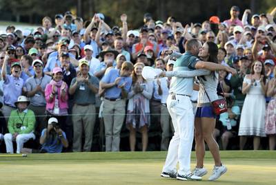 AUGUSTA, GA - APRIL 09: Sergio Garcia of Spain embraces fiancee Angela Akins in celebration after defeating Justin Rose (not pictured) of England on the first playoff hole during the final round of the 2017 Masters Tournament at Augusta National Golf Club on April 9, 2017 in Augusta, Georgia.   David Cannon/Getty Images/AFP