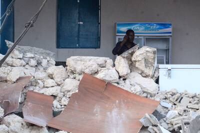 A hotel security guard stands in the rubble of Pearl Beach Hotel in Lido Beach after Friday's attack by an armed column reported to belong to Al Shabab. Police put the death toll at six on Saturday. EPA

