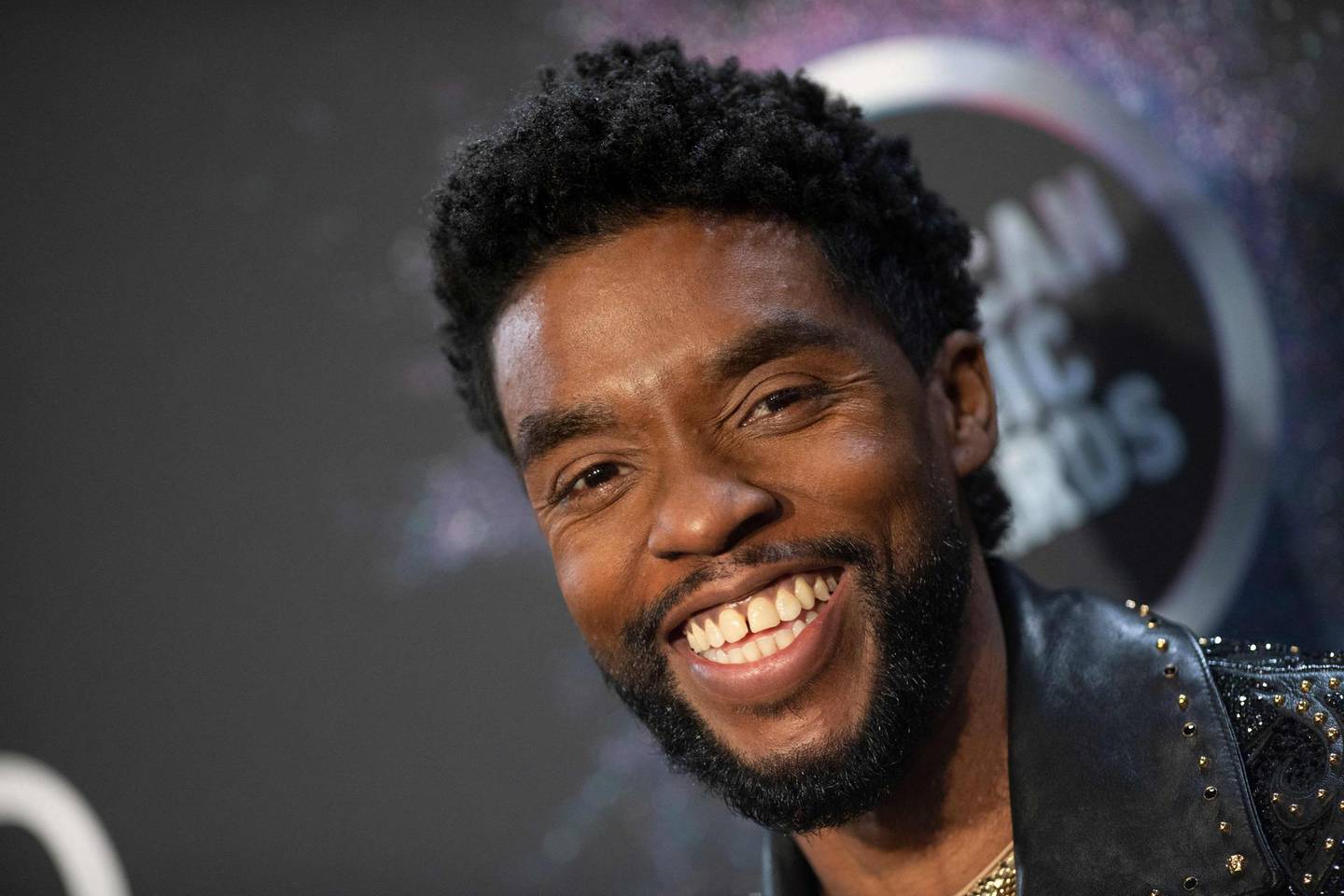 (FILES) In this file photo taken on November 24, 2019 US actor Chadwick Boseman poses in the press room during the 2019 American Music Awards at the Microsoft theatre in Los Angeles. Chadwick Boseman, who died of cancer last August, was posthumously voted best actor for 1920s blues drama "Ma Rainey's Black Bottom" by Hollywood's actors guild during the virtual SAG awards on April 4, 2021. / AFP / Valerie MACON
