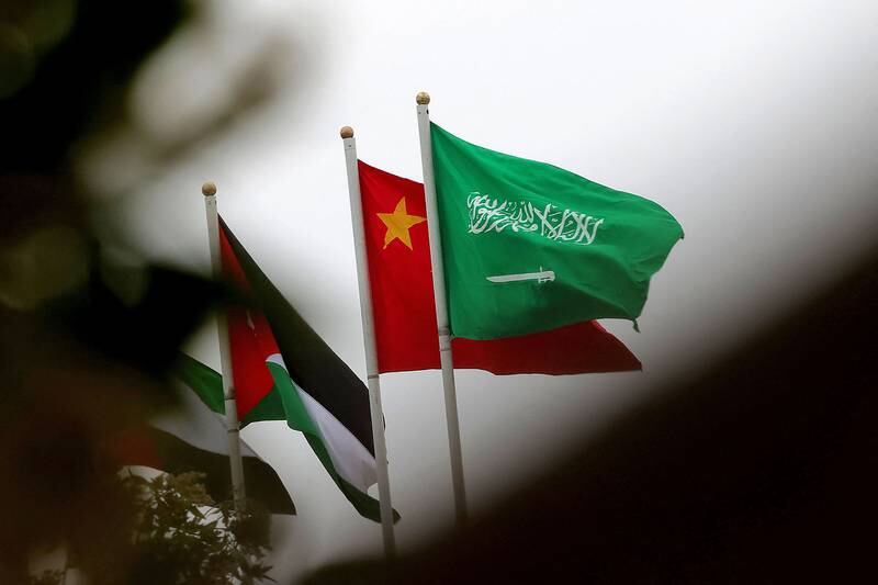 Saudi and Chinese flags adorn a street a street in Riyadh before the arrival of Mr Xi. AFP
