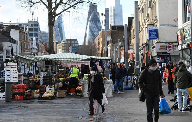 People shop at a local market in London. EPA
