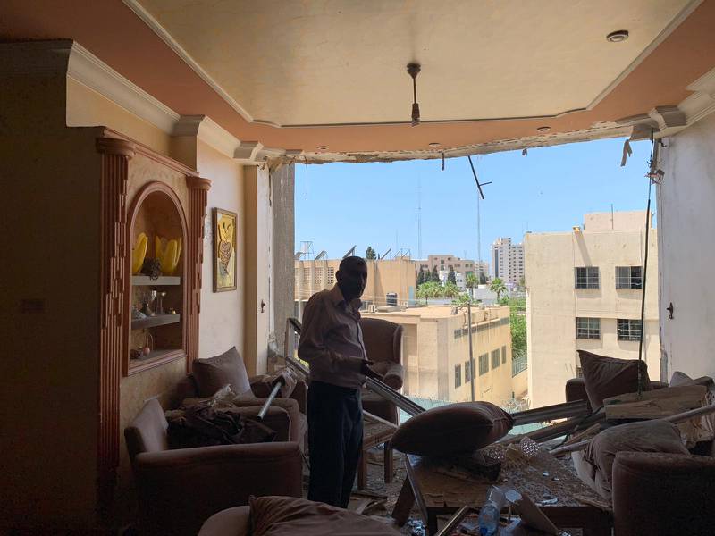 Abu Alkas looks at the damage to his home caused by Israeli airstrikes in Gaza. Nagham Mohanna for The National