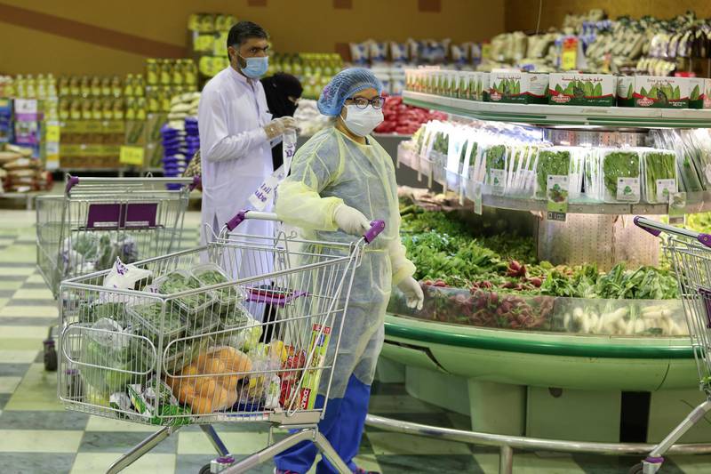 A woman wears a protective suit, as she shops at a supermarket, following the outbreak of the coronavirus disease in Riyadh. REUTERS
