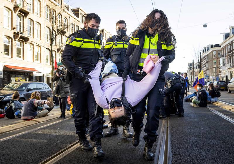 Dutch police remove an Extinction Rebellion protester in Amsterdam, the Netherlands. Environmental activists had blocked the Overtoom, a street in the west of the city. EPA