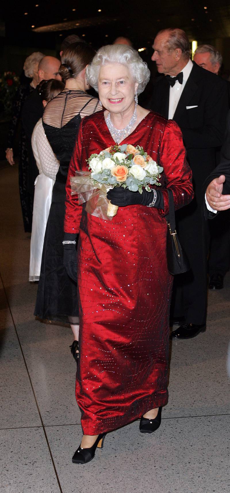Queen Elizabeth II, wearing a red gown with crystal detailing, attends the Royal Variety Performance in Cardiff, Wales on November 21, 2005. Getty Images 