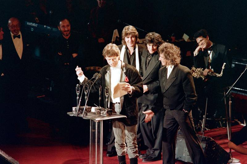 Mick Jagger, Mick Taylor, Ron Wood and Keith Richards of the Rolling Stones get together on January 18, 1989 in New York as thy are inducted into the Rock and Roll Hall of Fame. (Photo by Ron J. HAVIV / AFP)