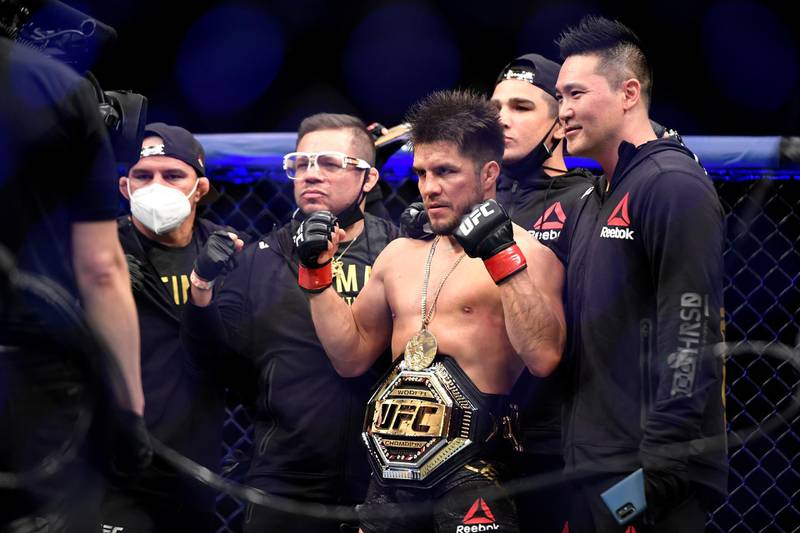JACKSONVILLE, FLORIDA - MAY 09: Henry Cejudo (L) of the United States celebrates defeating Dominick Cruz (not pictured) of the United States in their bantamweight title fight during UFC 249 at VyStar Veterans Memorial Arena on May 09, 2020 in Jacksonville, Florida.   Douglas P. DeFelice/Getty Images/AFP