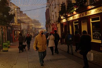 Christmas lights are seen as shoppers walk through the city centre during foggy weather in Galway, Ireland, December 7. Reuters