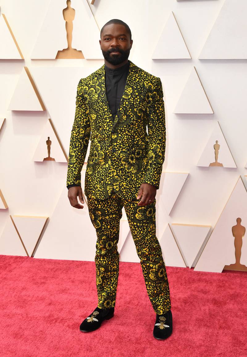 Actor and producer David Oyelowo wears a bold yellow-and-black floral suit. AFP