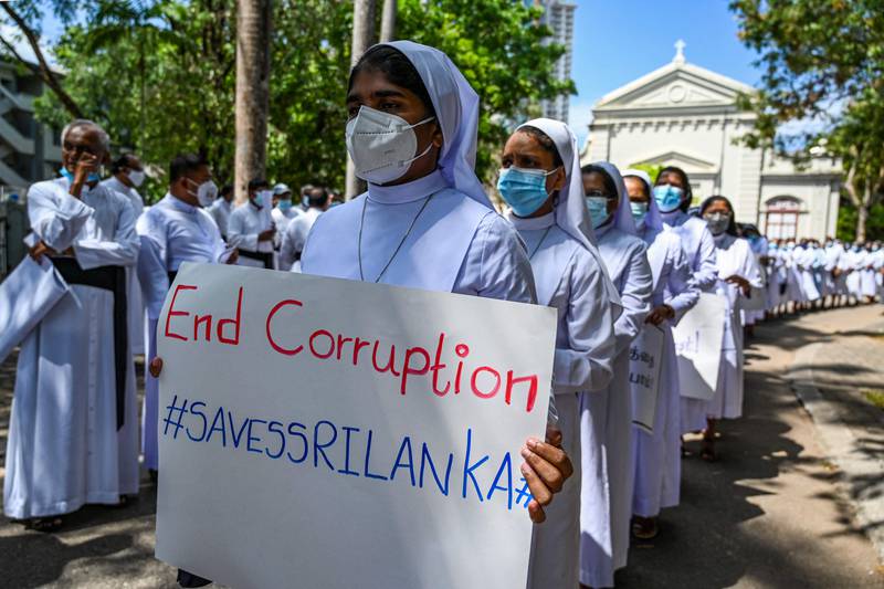 Catholic priests and sisters hold placards during a demonstration against the economic crisis in Colombo, the capital of Sri Lanka. All photos: AFP