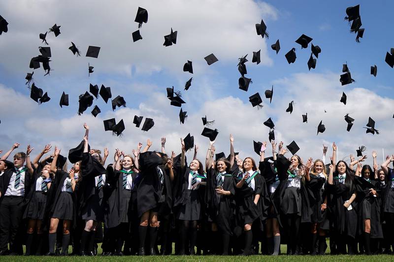 Year 11 students of the BBG Academy celebrate their graduation by throwing their mortarboard hats in the air. As the pandemic restrictions ease many schools and colleges in the UK are once again performing the graduation ceremonies and last day of school traditions. Getty Images
