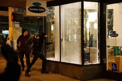 Demonstrators break a shop window in Portland, Oregon,  on November 11, 2016 during a protest against the election of Republican Donald Trump as president of the United States. William Gagan / Reuters