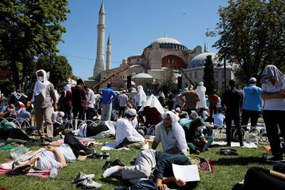 People wait for the beginning of Friday prayers outside Hagia Sophia. Reuters