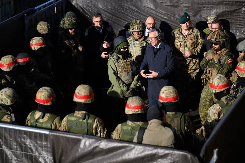Jens Stoltenberg speaks with troops. 