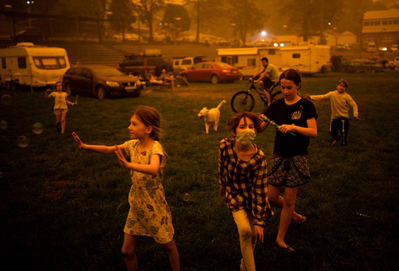 Children playing in the southern New South Wales town of Bega where they camped after being evacuated from nearby sites affected by bushfires, on December 31, 2019. Wildfires will rise sharply in coming decades due to global warming, and governments are ill-prepared for the death and destruction caused, the UN warned on February 23. AFP