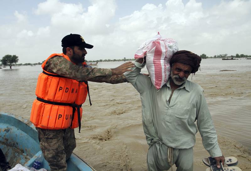 A man receives food, distributed by army troops in the flood-hit area of Rajanpur in Punjab, Pakistan, on August 27. AP