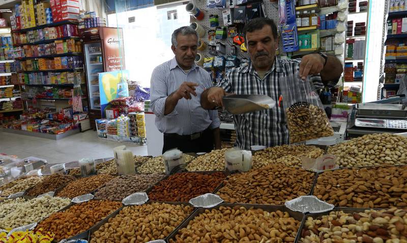 epa06933110 A shopper (R) weights Iranian pistachios at a popular market in Abu Dhabi, United Arab Emirates, 07 August 2018. The US sanctions were reimposed on some of Iranian products which came a step after US President Donald J. Trump has withdrawn from Iran nuclear deal, the US sanctions aiming to increase the pressure on Iranian economy. The ban is including the export of Iranian carpets and pistachios to the US.  EPA/ALI HAIDER