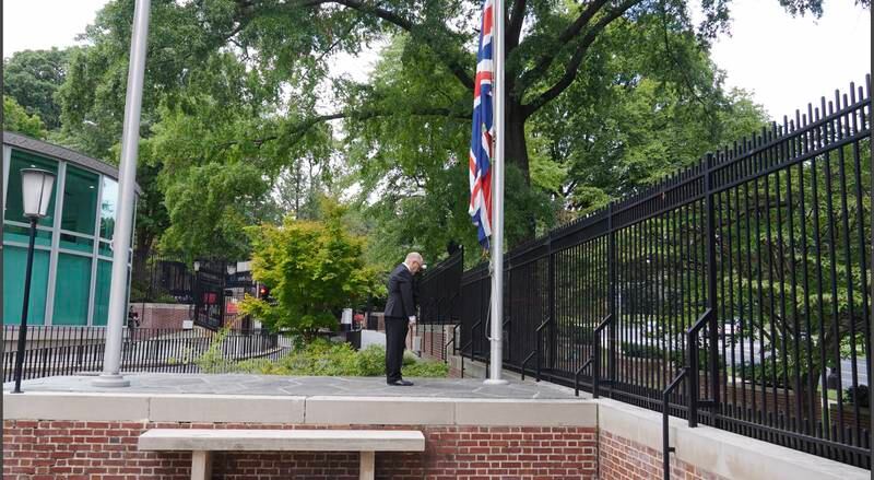 Frame grab from a video showing a member of the British Embassy staff lowering the flag outside the embassy to half staff upon news of the death of Queen Elizabeth II in Washington, DC, USA, 08 September 2022. EPA