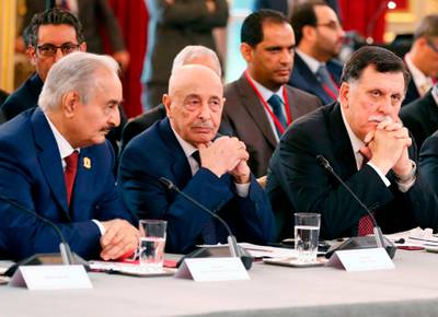 (FILES) In this file photo taken on May 29, 2018 (L to R) Libyan strongman Khalifa Haftar,  speaker of the eastern-based parliament Aguila Saleh Issa, and head of the Tripoli-based UN-recognised unity government Fayez al-Sarraj, attend an International Congress on Libya at the Elysee Palace in Paris. Libya's warring rival governments announced in separate statements signed by Sarraj, Saleh and Haftar on August 21, that they would cease all hostilities and organise nationwide elections soon, an understanding swiftly welcomed by the United Nations.
 / AFP / POOL / Etienne LAURENT

