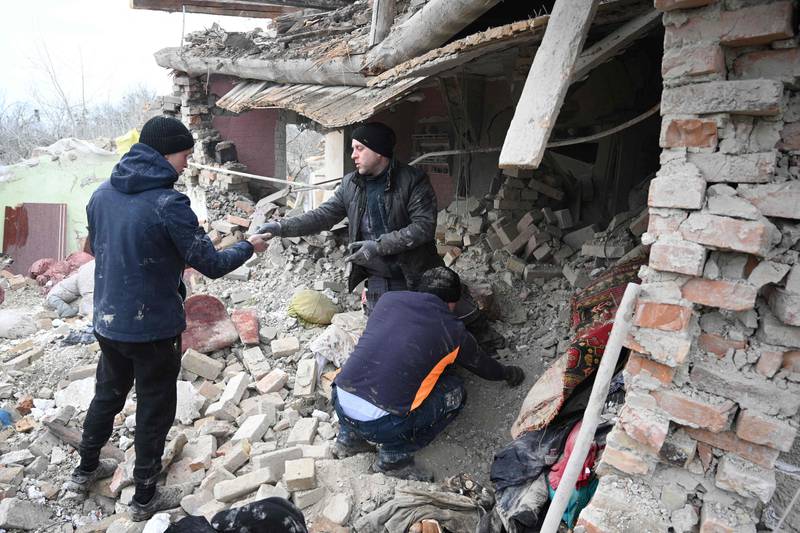 People search the rubble of a house following a Russian strike in the village of Velyka Vilshanytsia, some 50km from Lviv. AFP