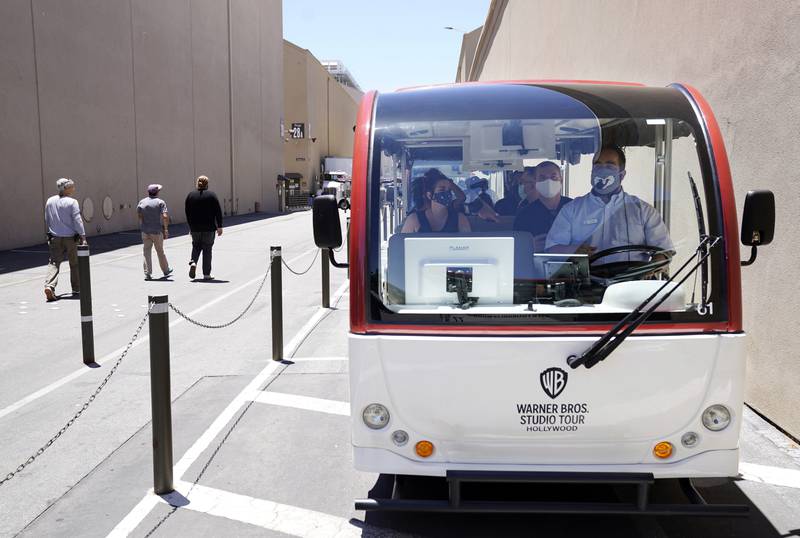 A tour guide drives visitors through the Warner Bros lot during the Warner Bros Studio Tour Hollywood media preview.