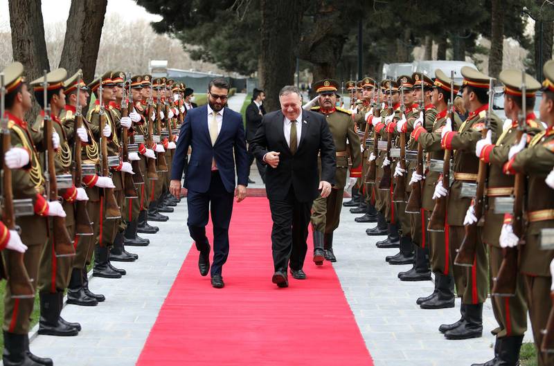 U.S. Secretary of State Mike Pompeo, right, and Afghanistan's National Security Adviser Hamdullah Mohib, arrives at the Presidential Palace in Kabul, Afghanistan. Afghan Presidential Palace via AP