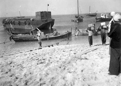 Abu Dhabi's Corniche in the 1950s. Some boats could unload goods on the beach, while larger vessels docked farther out. Photo: Tim Hillyard