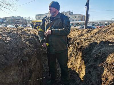 A volunteer from Kiev prepares a rear post with trenches in the city. AFP