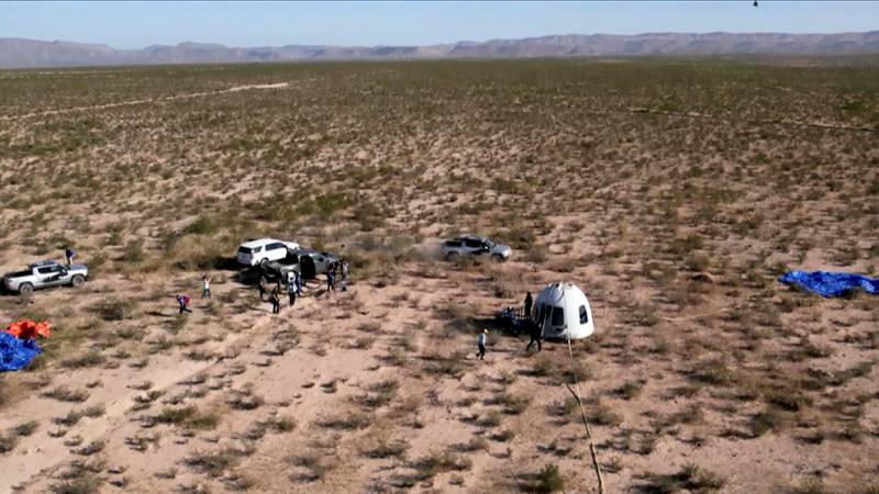 The capsule of Blue Origin’s New Shepard mission NS-18 is surrounded by ground crew after landing by parachute near Van Horn, Texas, in a still image captured from video. Reuters
