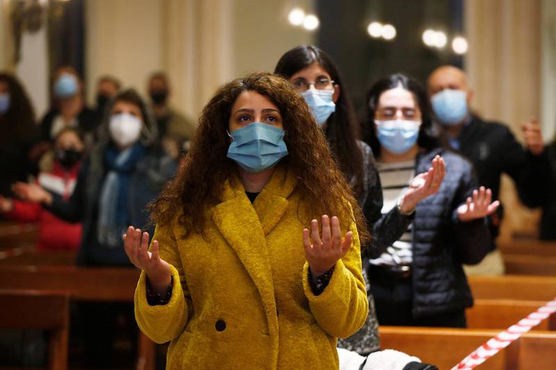 Faithfuls wearing protective masks and maintaining social distance attend a mass before turning on the lights on the Christmas tree, at Church of the Sacred Heart, amid fears over rising numbers of coronavirus disease cases in downtown Amman, Jordan. Reuters