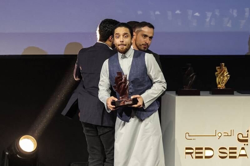 Saudi director Hamzah Jamjoom of 'Rupture' celebrates winning the Best Saudi Film award during the awards ceremony of the first edition of the Red Sea Film Festival. Photo: Fayez Nureldine  /  AFP