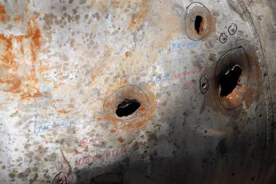 Holes caused by fragments of a missile are seen in a damaged pipe in the Aramco's Khurais oil field. AP Photo