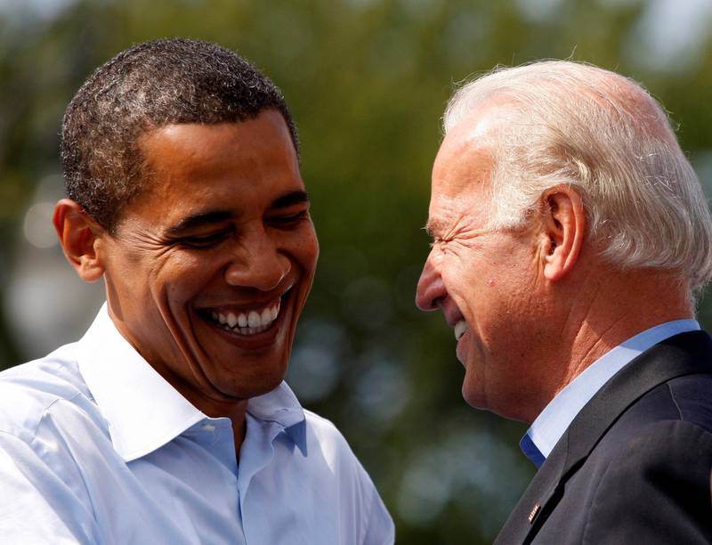 FILE PHOTO: Democratic presidential nominee Senator Barack Obama (D-IL) and his vice presidential running mate Senator Joe Biden (D-DE)  share a laugh on stage during a campaign rally in Detroit, Michigan, U.S., September 28, 2008.     REUTERS/Jason Reed/File Photo