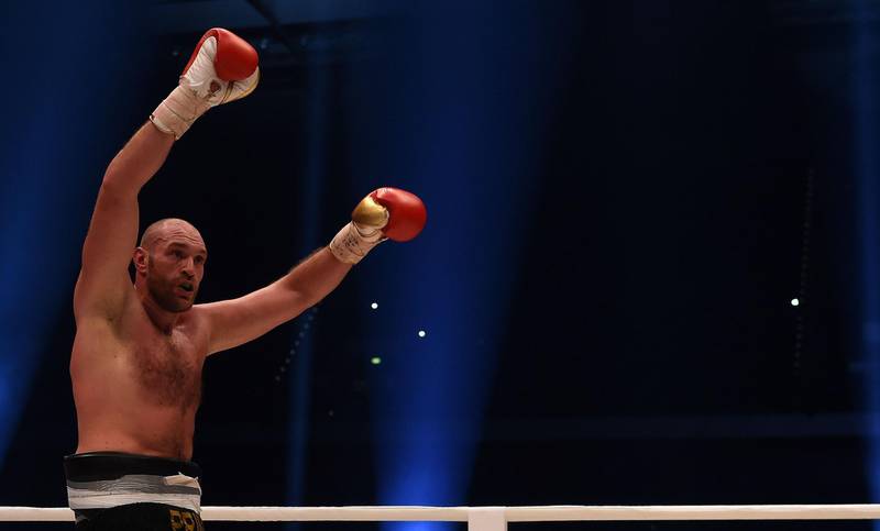 (FILES) This file photo taken on November 28, 2015 shows British Tyson Fury celebrating after the WBA, IBF, WBO and IBO title bout against Ukrainian world heavyweight boxing champion Wladimir Klitschko in Duesseldorf, western Germany.
Britain's former heavyweight world champion Tyson Fury is free to resume his boxing career after a compromise on his positive test for a banned steroid was found with UK Anti-Doping, it was announced on December 10, 2017. / AFP PHOTO / PATRIK STOLLARZ