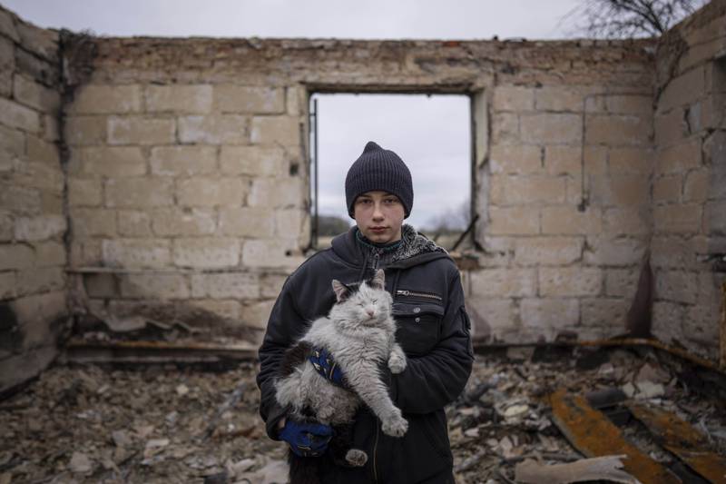 Danyk Rak, 12, in the debris of his house, which was destroyed by Russian shelling in the outskirts of Chernihiv, Ukraine. Danyk's mother Liudmila Koval had to have her leg amputated after the attack in which she also suffered abdominal injuries. She is still waiting for proper medical treatment. AP