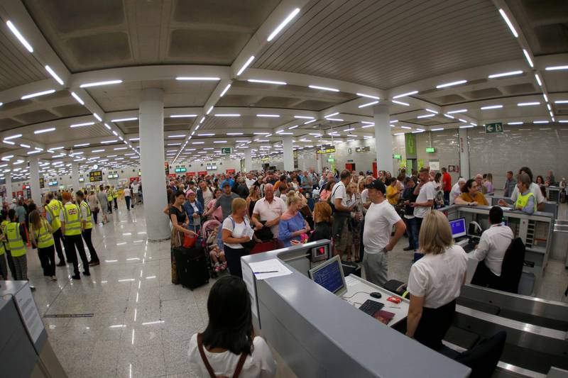 Passengers are seen at Thomas Cook check-in points at Mallorca Airport, Spain. Reuters