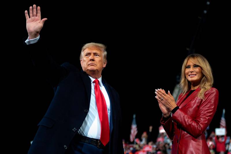US President Donald Trump waves as he leaves the stage with First Lady Melania Trump at the end of a rally to support Republican Senate candidates at Valdosta Regional Airport in Valdosta, Georgia. AFP