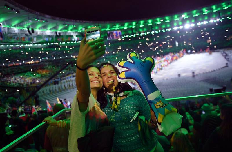 Spectators take a “selfie” at the Closing Ceremony of the Rio 2016 Olympic Games, at the Maracana Stadium on August 21. Ed Jones / AFP.