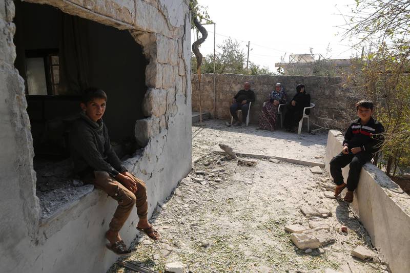 Children sit by their damaged home in the village of Barisha in Idlib province, Syria, on Sunday, October 27, 2019, after an operation by the US military which targeted Abu Bakr Al Baghdad. AP Photo