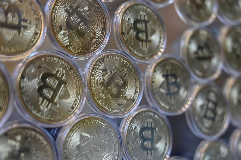 This photograph taken on December 17, 2020 shows shows a physical imitation of a Bitcoin at a crypto currency "Bitcoin Change" shop, near Grand Bazaar, in Istanbul. Leading virtual currency bitcoin on 16 December traded above $20,000 for the first time following a sustained run higher in recent weeks. Bitcoin reached a record-high $20,398.50 before pulling back to $20,145, which was still an intra-day gain of nearly four percent. / AFP / Ozan KOSE
