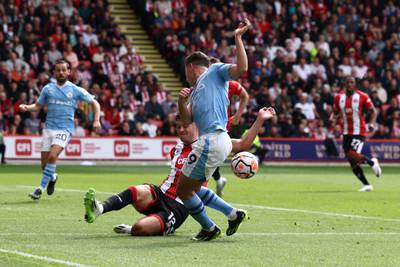 Sheffield United's John Egan handles the ball to concede a penalty. AFP