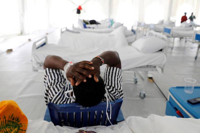 A Covid-19 patient reacts after being tested inside a field hospital built on a football stadium in Machakos, as the number of confirmed Covid-19 cases continues to rise in Kenya. Reuters