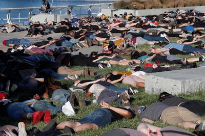 Demonstrators lie face down with their hands behind their backs during a protest in Oakland, California.  EPA